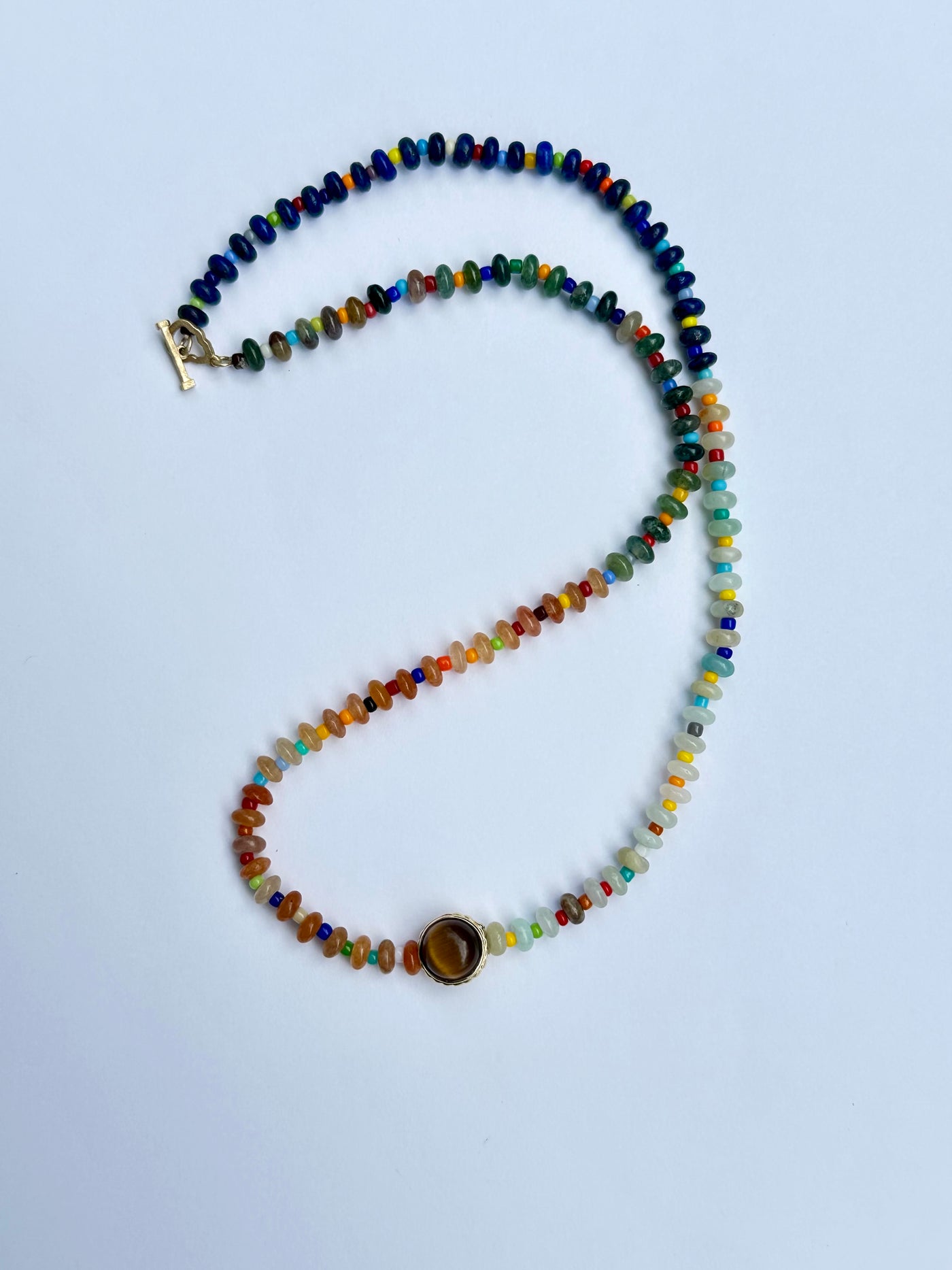 luis morais multicolored beaded 16" necklace 14k gold skull toggle clasp with collared cabochon tigers eye and balance symbole